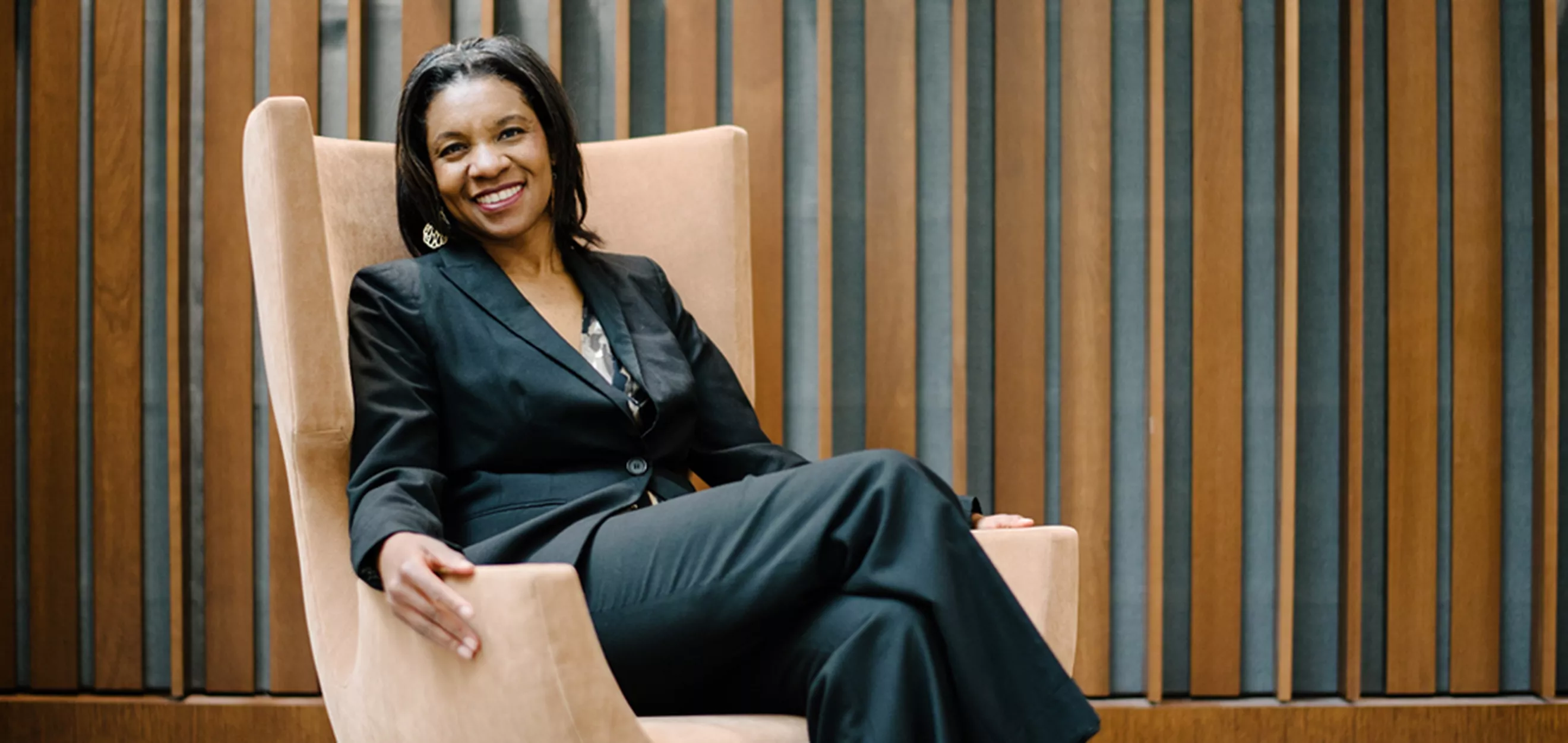 Erika George reclined in a comfortable chair in professional attire